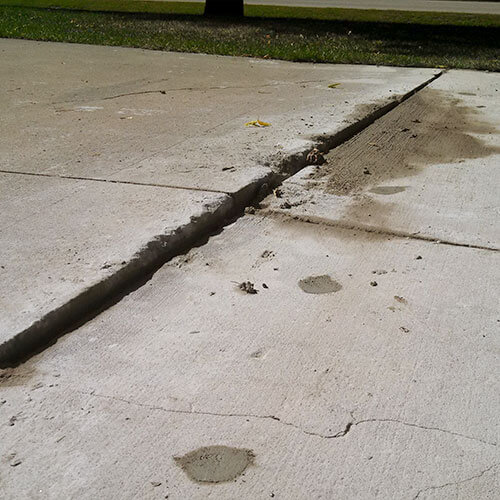 Uneven concrete driveway Cracked uneven driveway