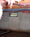 California crawl space with vents, showing mold, rot, and fiberglass insulation dripping off the ceiling.