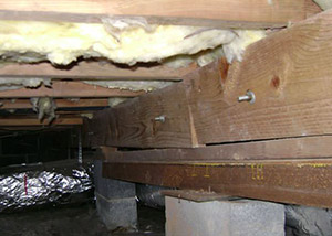 sagging crawl space with wooden shimming a Garden Grove crawl space
