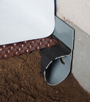 Closeup of a crawl space drainage system installed in Rancho Cucamonga